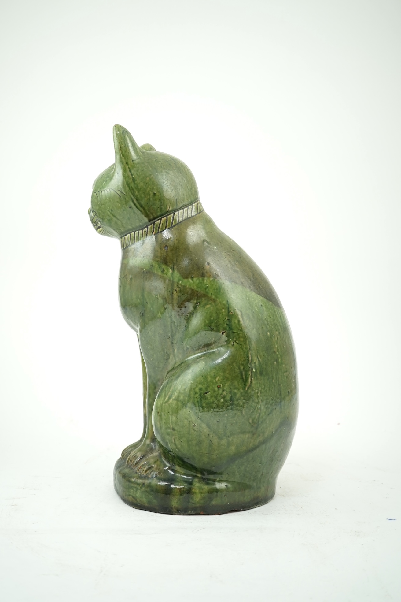 Ewenny Pottery: A large green-glazed figure of a seated cat